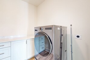 A compact kitchen with a built-in oven and a microwave. - Palmilla Beach Resort-186 Sunrise Avenue (Port Aransas)
