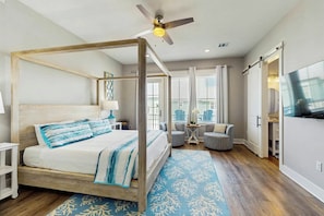 A four-poster bed with a wooden frame and a blue and white patterned bedspread. - Palmilla Beach Resort-191 Stargrass Lane (Port Aransas)