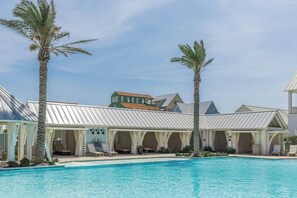 A resort with a swimming pool, palm trees, and covered outdoor seating areas. - Palmilla Beach Resort-193 Sunset Avenue (Port Aransas)