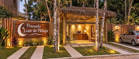 A reception area with a signboard, a reception desk, and a seating area.