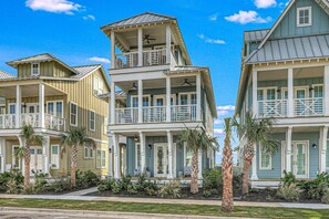 A beachfront property with multiple-story buildings, balconies, and palm trees. - Palmilla Beach Resort-224 Sunrise Avenue (Port Aransas)