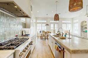 A spacious kitchen with a large island, modern appliances, and ample natural light. - Palmilla Beach Resort-264 Sunrise Avenue (Port Aransas)