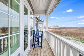 A covered porch with a view of a coastal landscape. - Palmilla Beach Resort-284 Sunrise Avenue (Port Aransas)