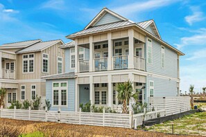 A multi-story beachfront house with a balcony, a covered porch, and a white fence. - Palmilla Beach Resort-408 Mermaid Tail Lane (Port Aransas)
