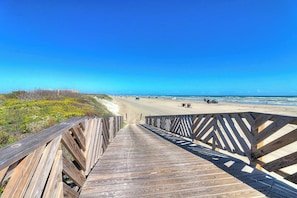 A wooden boardwalk leading to a beach with clear skies. - Palmilla Beach Resort-416 Mermaid Tail Lane (Port Aransas)