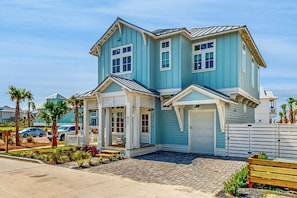 A two-story house with a garage, a covered porch, and a small deck. - Palmilla Beach Resort-427 Mermaid Tail Lane (Port Aransas)