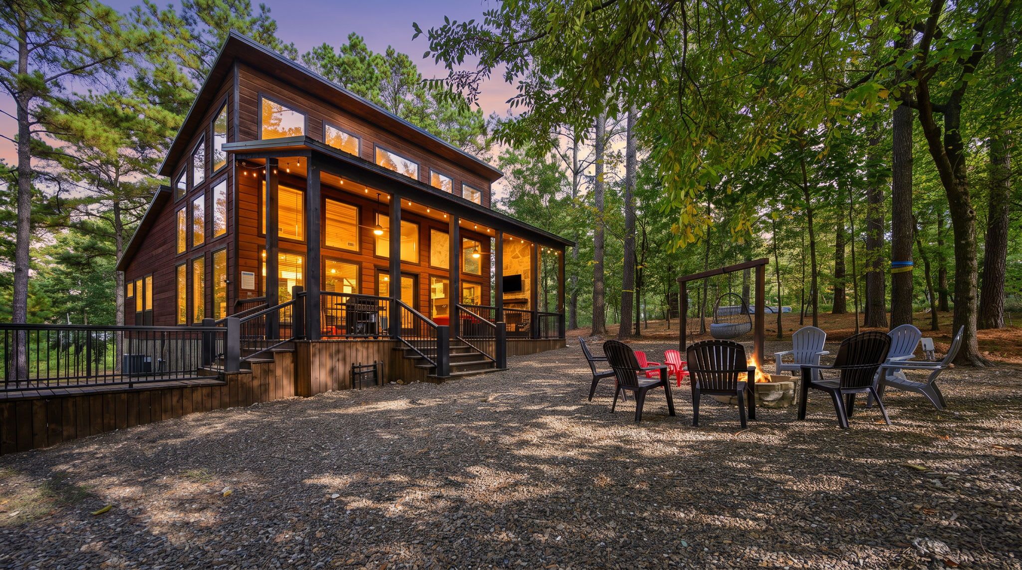 A cabin with a deck, outdoor seating, and a fire pit.