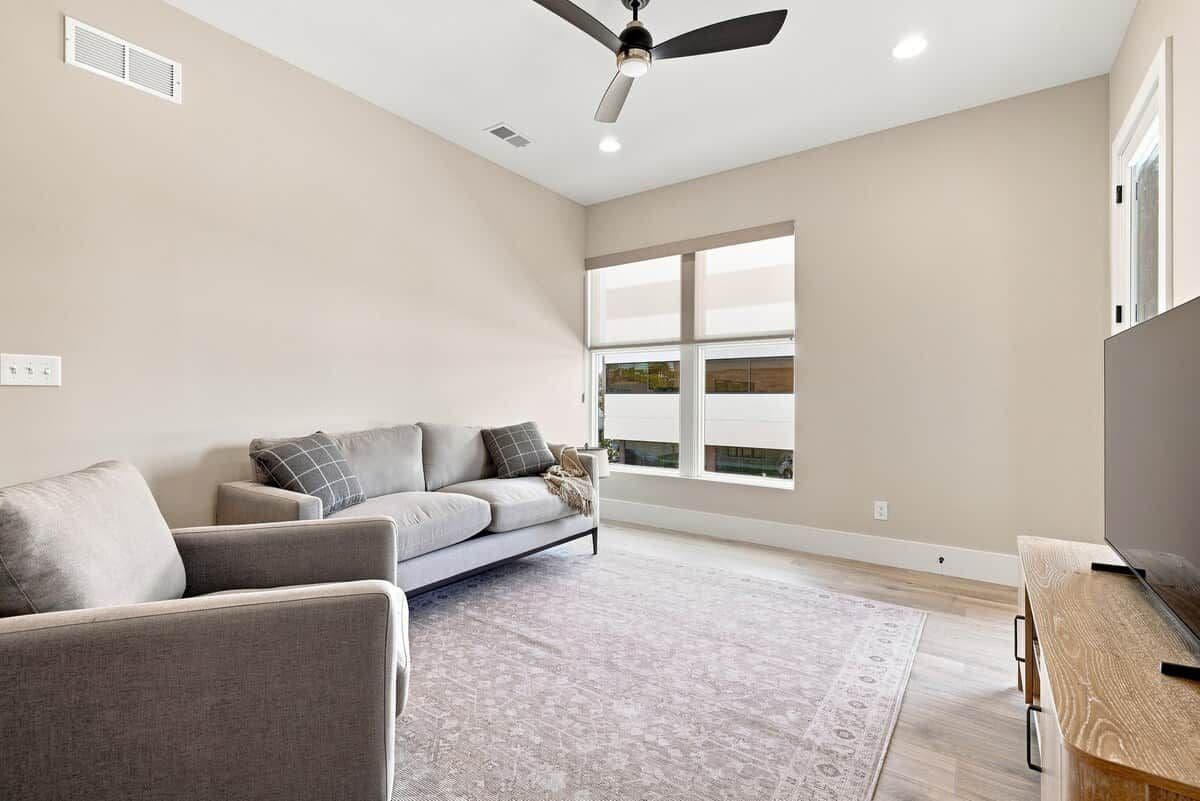 A spacious living room with a sofa, a coffee table, and a TV stand.