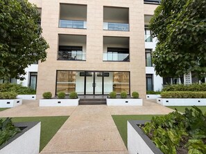 A modern building with a symmetrical facade, large windows, and a central entrance. - Ebs properties Africa limited  (Accra)