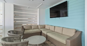 A covered outdoor seating area with a sectional sofa, wicker chairs, and a round table. - Ocean-View Home | 7BR Retreat (Panama City)