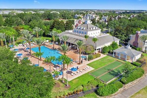 Ein Resort mit Schwimmbad, Liegebereichen und einer großen Rasenfläche.