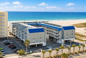 A beachfront hotel with multiple buildings, parking, and a view of the ocean. - 3BR Gulf Front condo with Amazing Views - sleeps 10 - Pet Friendly (Gulf Shores)