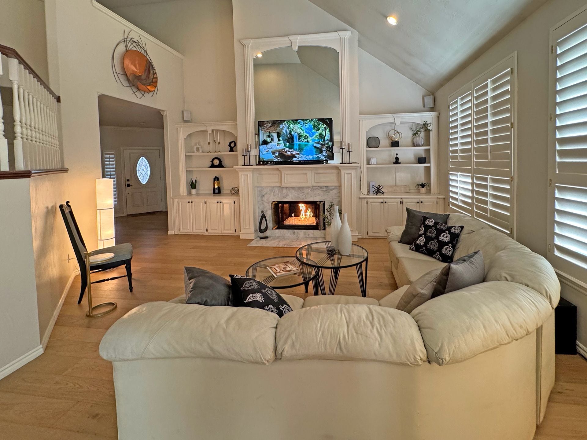 A living room with a fireplace, a television, and a sofa.