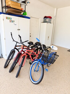 A storage area with bicycles and a cabinet labeled 'BEACH STUFF IN HERE'.
