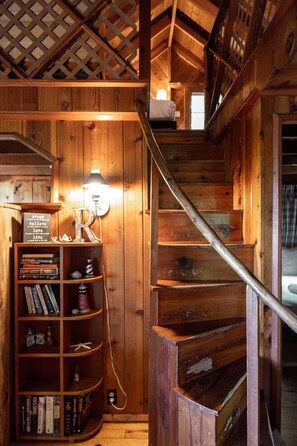 A wooden staircase with a metal handrail leading to a loft area. - CRO's Terrapin Station Lakeside | Waterfront | Dock | Firepit | Sunsets | (Maple City)