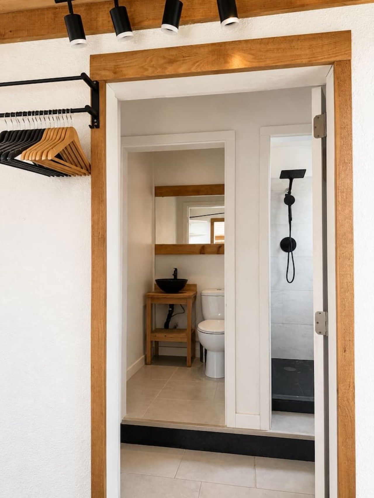 A bathroom with a toilet, sink, and shower.