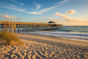 A wooden pier extending into the ocean with a covered structure at the end. - 3BR, 2BA Magnolia Lakes condo in Myrtle Beach, sleeps 6. (Myrtle Beach)