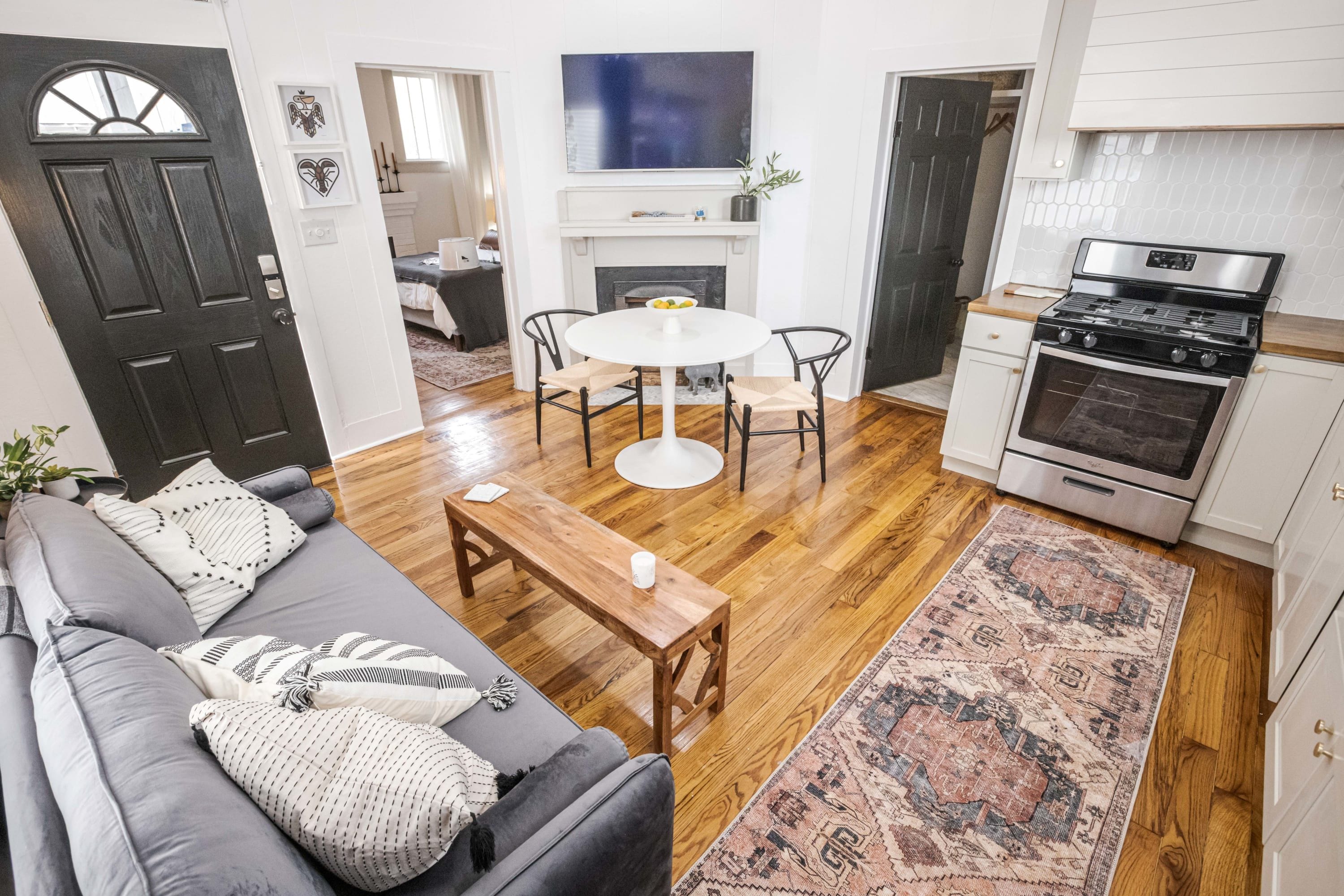 Historic Charm meets Modern Comfort: Enjoy the original hardwood floors and cozy seating by the decorative fireplace.