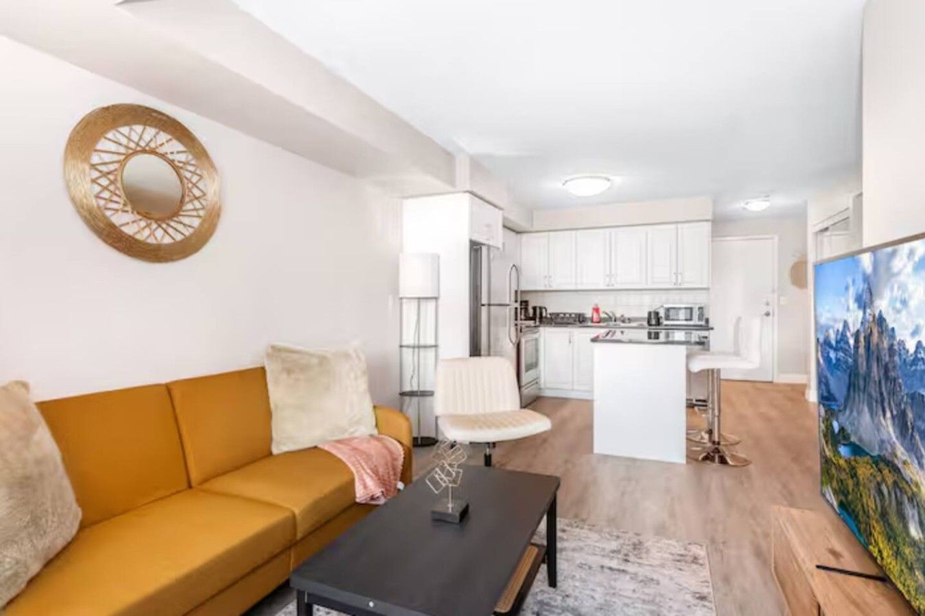 A modern apartment with a living room, a dining area, and a kitchen.