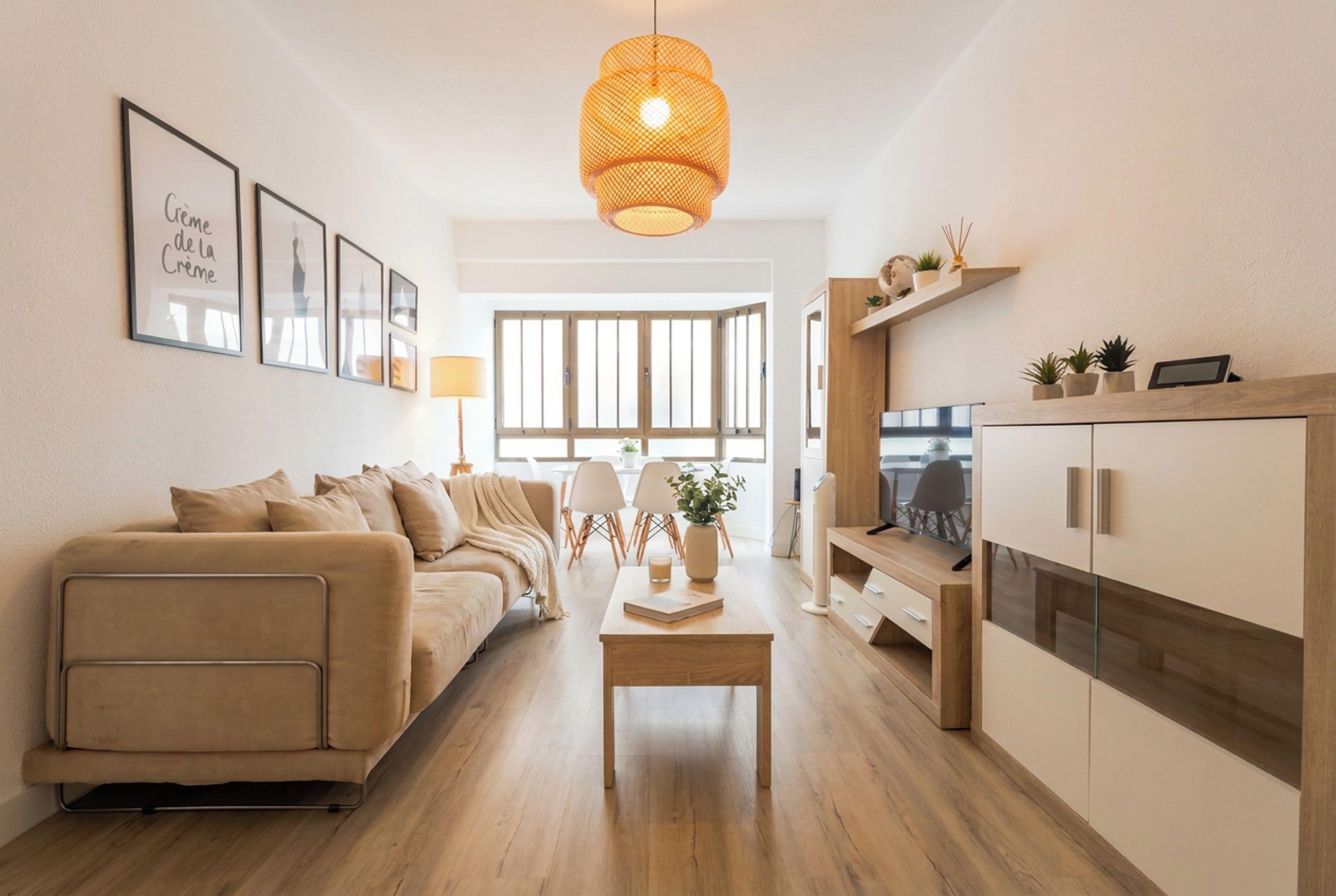 A modern living room with a sofa, a coffee table, and a TV stand.