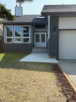 A residential house with a garage, a front door, and a number '40' on the wall. - Beautifull Luxury House by Canion Meadows Golf Course (Calgary)