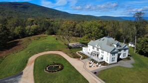 A large white house with a spacious porch and a well-maintained lawn. - Everett Estate | Modern Luxury Meets Historic Charm (Nellysford)