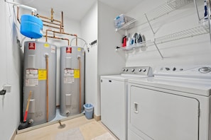 A laundry room with two water heaters, a washing machine, and a dryer. - Spacious 4BR Beaver Creek Ski In Ski Out Townhome (Beaver Creek)