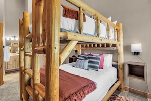 A bunk bed with a wooden frame, a white mattress, and patterned pillows. - Timber Wolf 11B | Creekside | Canyons Village | Hot Tubs | Fireplace | Free Bus (Park City)