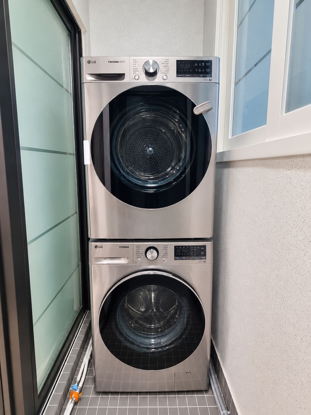 A stacked washer and dryer unit with a digital display and control panel.