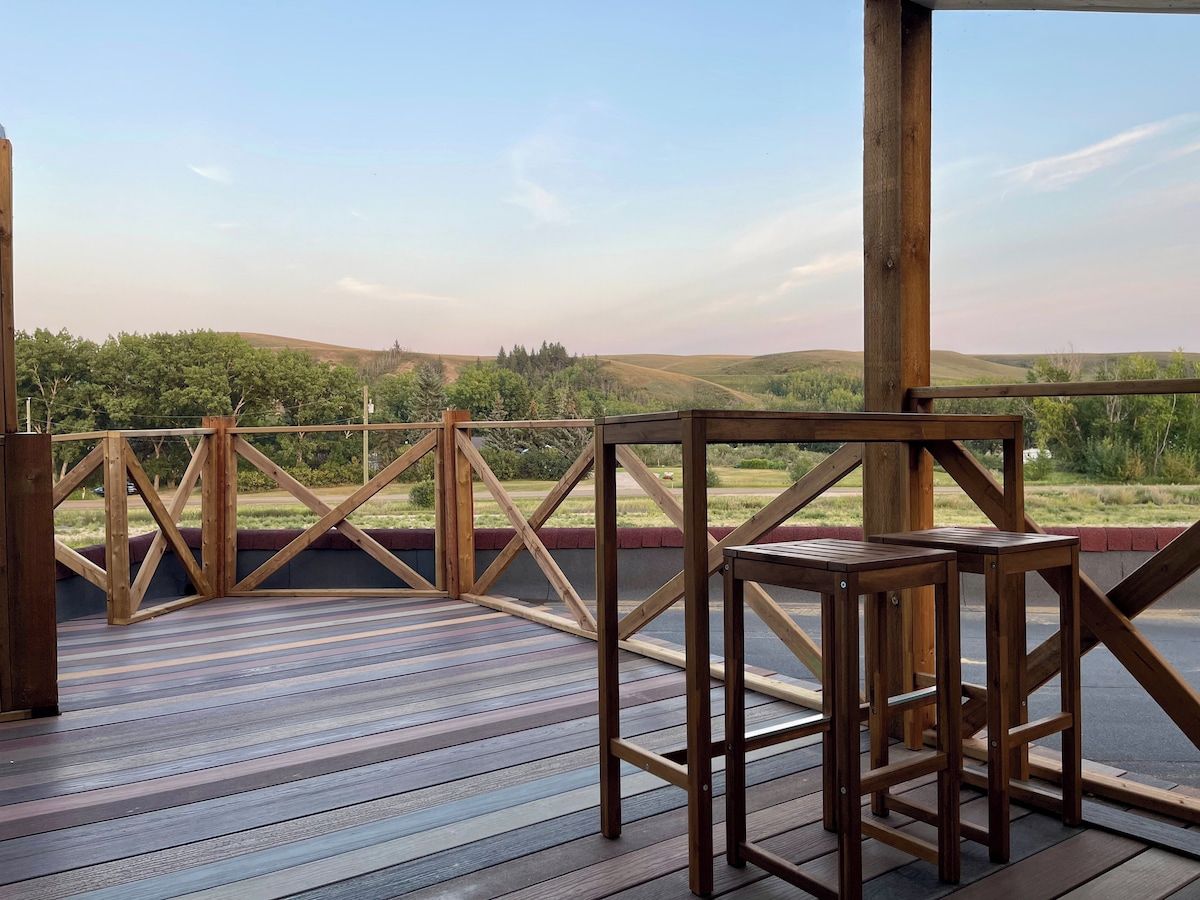 An outdoor deck with a wooden railing and a table.
