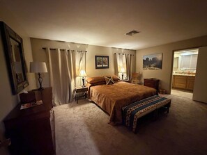 A bedroom with a large bed, two bedside tables, a nightstand, a dresser, and a window with curtains. - Awake to Bell Rock, Courhouse Butte & Castle Rock; Walk to trails & more! (Sedona)