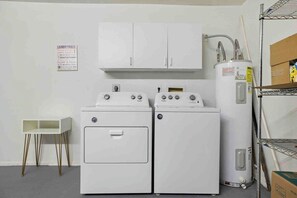 A laundry room with two front-loading washers, a tall water heater, and a cabinet above. - Scottsdale Sahuaro Villa 🌵⛳ Private Pool Near Mayo Clinic & McDowell Mtns (Scottsdale)