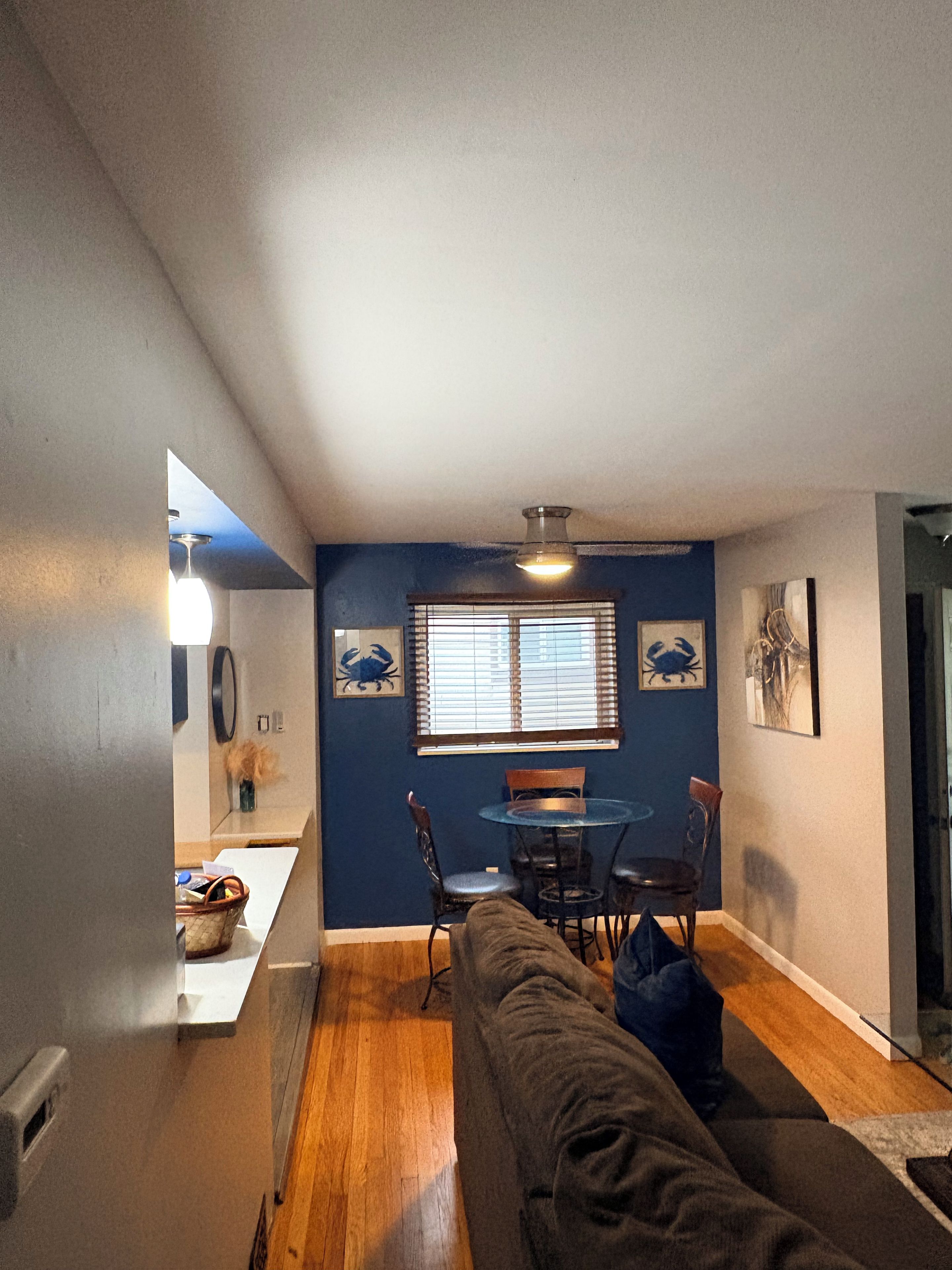 A compact living space with a dining area, a couch, and a small table.
