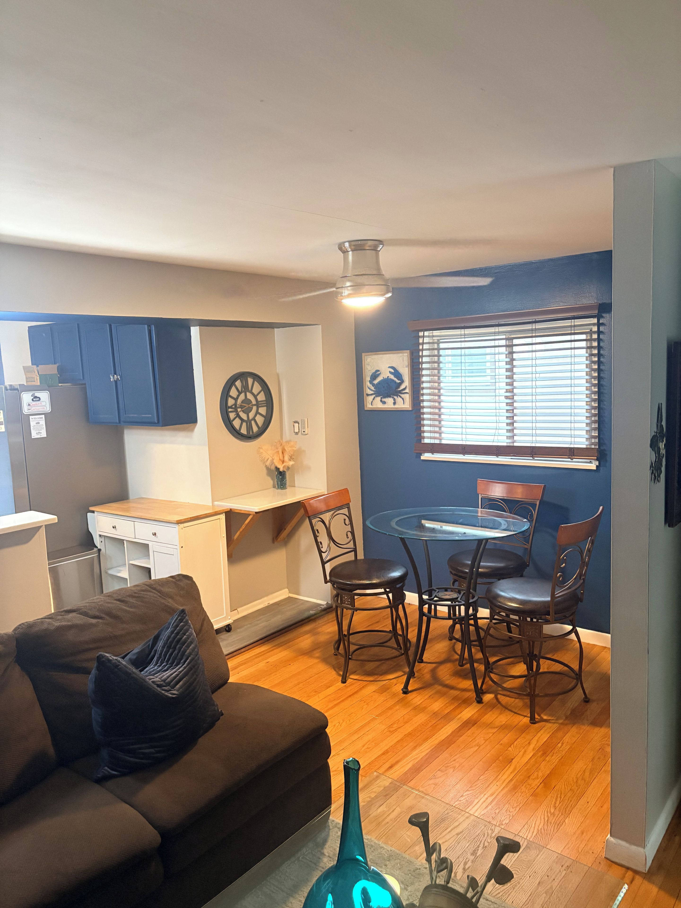 A compact living space with a kitchenette, dining area, and seating.