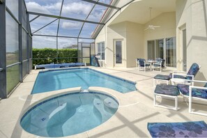 A swimming pool with a hot tub, surrounded by lounge chairs and a covered patio area. - Gorgeous 5 bed with south facing pool (Davenport)
