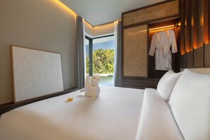 A hotel room with a bed, a framed abstract artwork, a window with a view of palm trees, and a rack with robes.