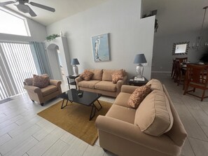A living room with a sofa set, a coffee table, and a dining area with chairs and a table. - Quiet cul-de-sac location (Davenport)