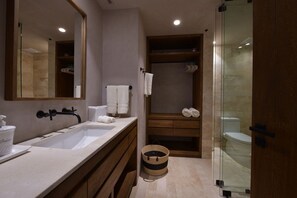 A modern bathroom with a large mirror, a sink, a shower, and a wooden vanity. - Pent Garden Azul Pac Fico (Punta de Mita)