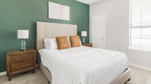 A bedroom with a bed, nightstands, and a door. - Landing | Stunning 1BD, Gym, Clubhouse (Katy)