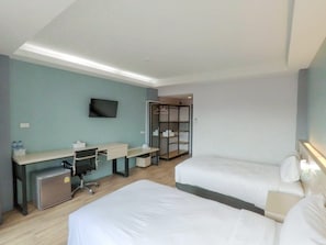 A hotel room with a desk, two beds, a TV, and a walk-in closet. - Mtrio Hotel Korat (Mueang Nakhon Ratchasima)
