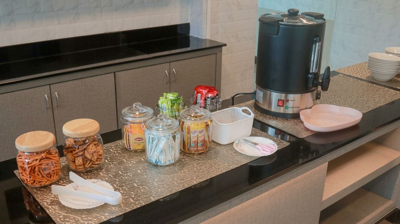 A kitchen counter with various food items, a coffee maker, and kitchenware.