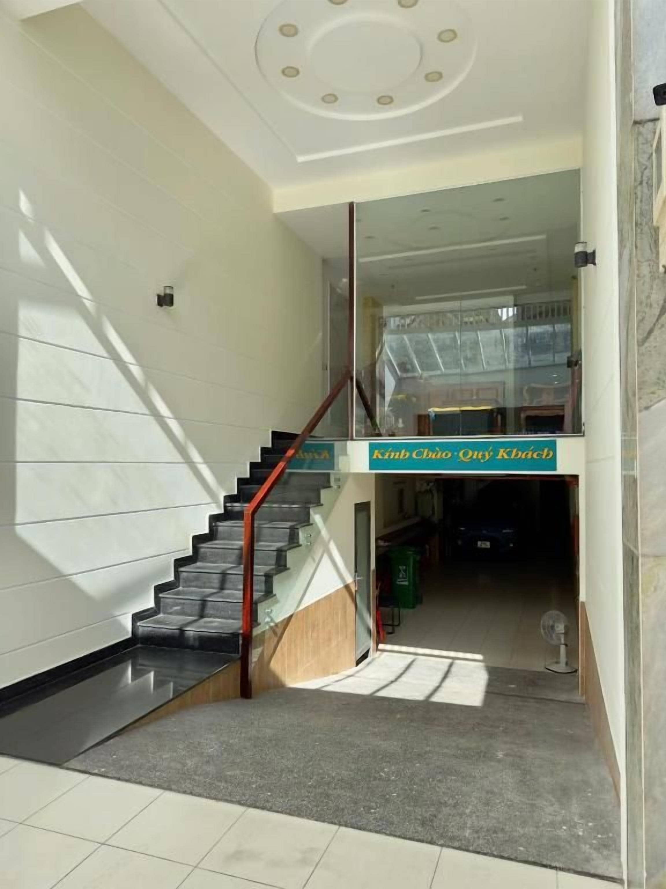 A staircase with a glass railing leading to a landing.