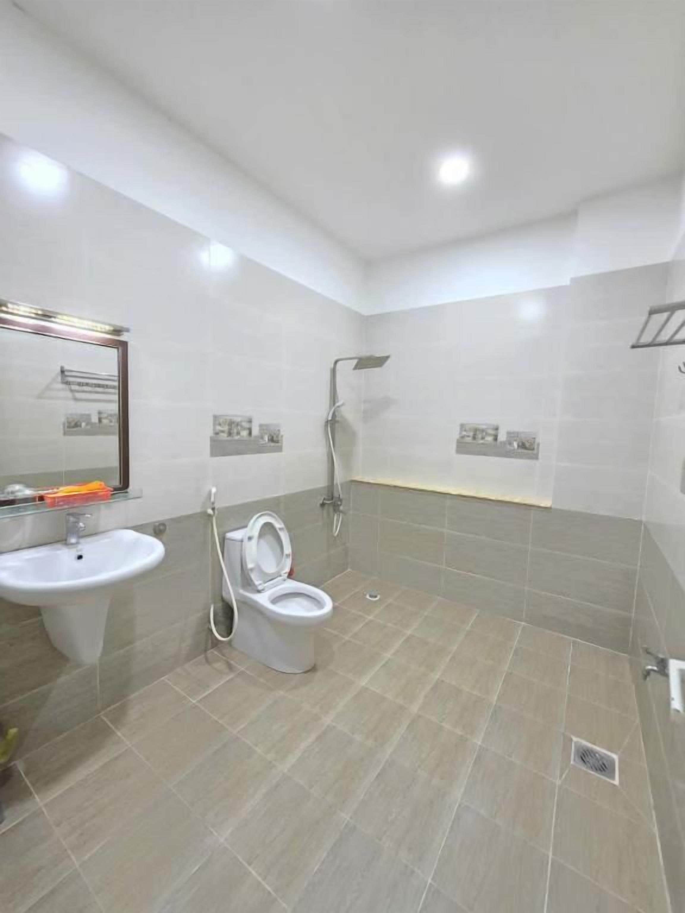 A bathroom with a sink, toilet, and shower.