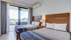 A hotel room with two beds, a balcony, and a view of the outdoors. - 406 Increible depa con jacuzzi priv y vista al mar (Nuevo Vallarta)
