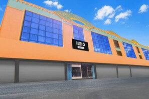 A hotel with a prominent 'HOTEL' sign, large windows, and a flat facade. - Hotel O Rayagada Downtown (Rayagarha)