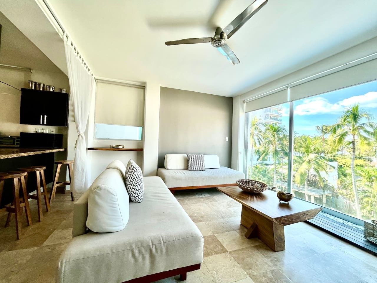 A modern living room with a sofa, a coffee table, and a television.