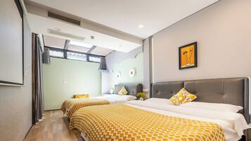 A hotel room with two beds, a large window, a wall-mounted artwork, and a ceiling vent.