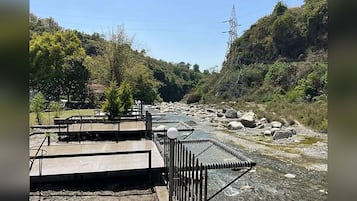 A river with a metal railing and a concrete platform.
