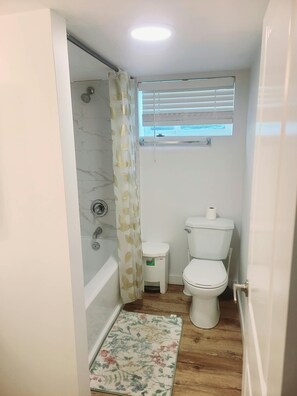 A compact bathroom with a shower, toilet, and a small window for natural light. - Central Cozy Haven! Private Room, Self Check-In, U of A, NAIT (Edmonton)
