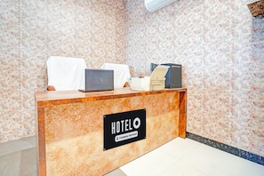 A hotel reception desk with a sign that reads 'HOTELO Company-Serviced'. - Super Hotel Kalpi Formerl Gajanand (Gwalior)